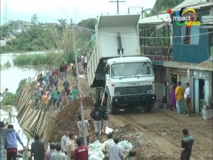 People repair bank of Imphal River at Singjamei