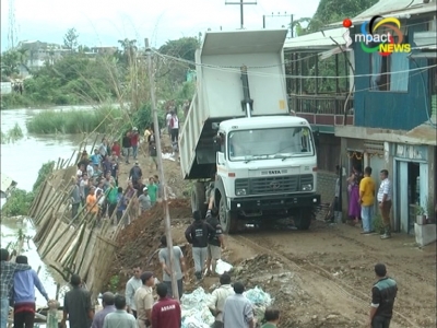 People repair bank of Imphal River at Singjamei