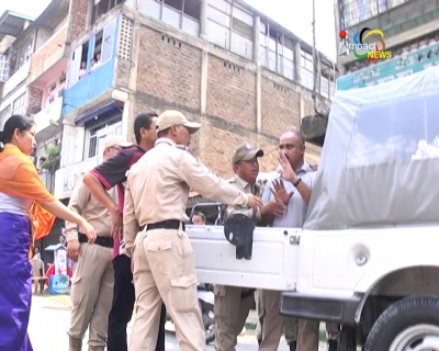 Shops down shutters in Paona Bazar over police drive against shops without lighting outside, police assaults 2 persons during the drive