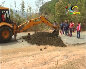 Owners and Drivers of Tata D-I repair pot holes on National highway 102, Indo-Myanmar road